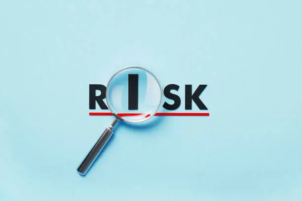 A graphic with risk and a magnifying glass.